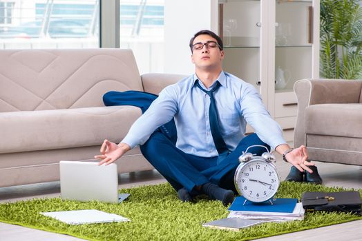 Businessman taking work home and working overtime