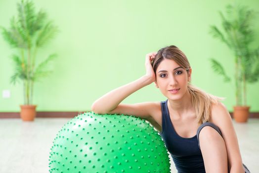 Woman doing exercises with swiss ball