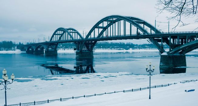 Ice floats on the Volga River.Automobile bridge in the city of Rybinsk, Russia.
