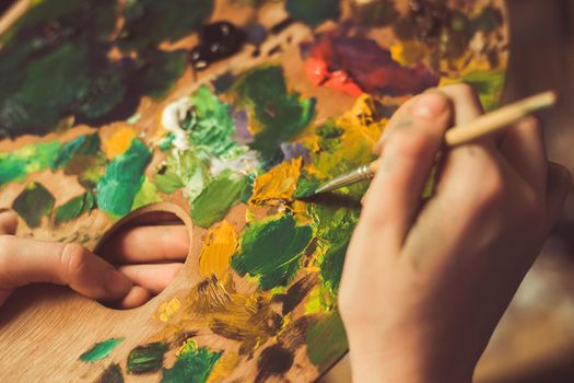 woman paints a picture with watercolor paint art. High quality photo