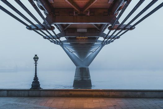 Underneath London's Millennium Bridge on a foggy morning