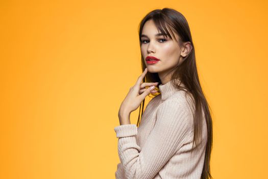 Cute brunette red lips fashionable clothes studio yellow background. High quality photo