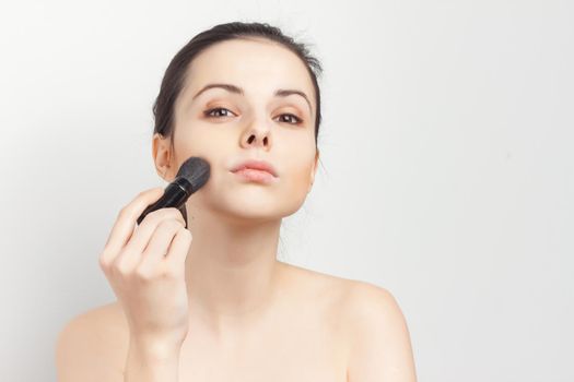 brunette bare shoulders face mask brushing cropped view skincare. High quality photo