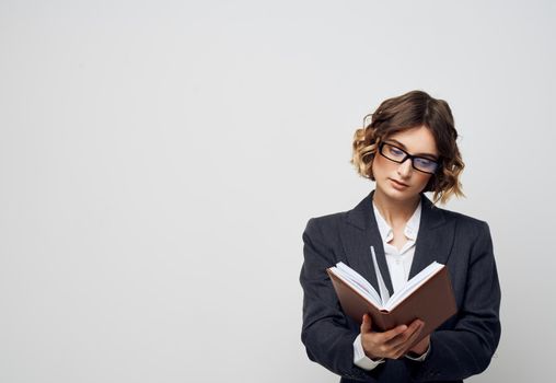 Woman with documents in hands classic suit and glasses hairstyle. High quality photo