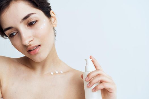 Pretty woman wears skin care cosmetics dermatology. High quality photo