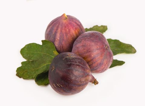 Fruits figs with fig leaves on white background