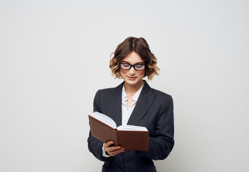 Business woman books documents model suit hairstyle glasses. High quality photo