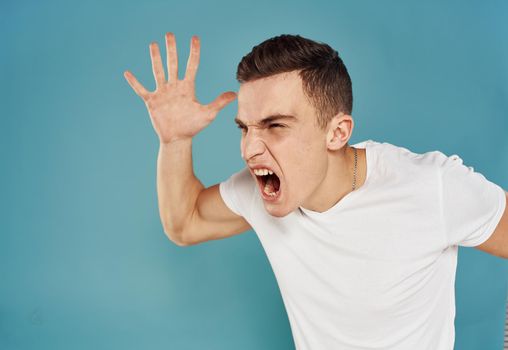 Energetic man clenched his hands into a fist and wide open mouth emotions model. High quality photo