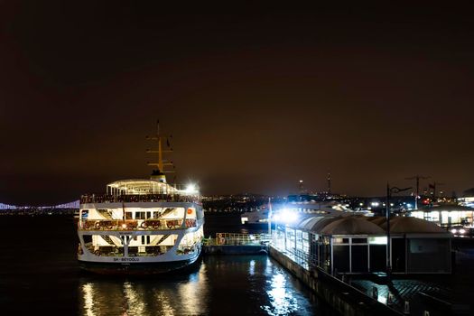 eminonu,istanbul,turkey-february 19,2021.city lines ferry at eminonu pier at dusk in the morning in istanbul city.