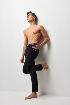 handsome male naked torso luxury black pants self-confidence model. High quality photo