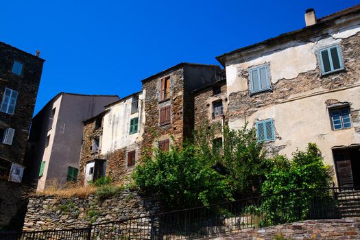 View on old houses in Corsican mountain village on a sunny day during summertime with a blue sky