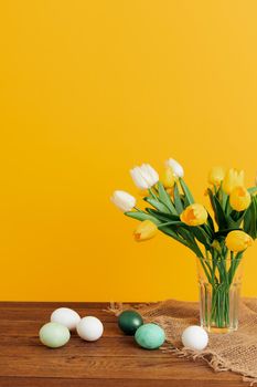 flower bouquet easter eggs spring holiday yellow background. High quality photo