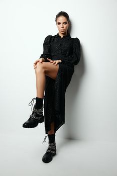 brunette in black dress modern style glamor studio. High quality photo
