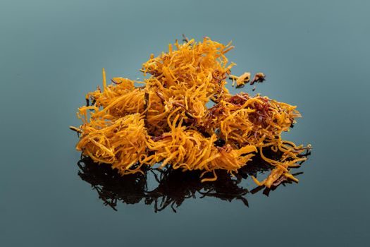 Thai sweets made from shredded sweet potato coated with sugar (Thai sweetmeat made of fried sweet potato) on blue table.  Copy spce, Selective focus.