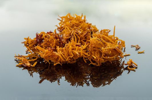 Thai sweets made from shredded sweet potato coated with sugar (Thai sweetmeat made of fried sweet potato) on white table.  Copy spce, Selective focus.