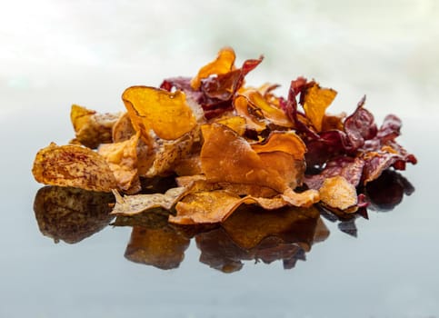 Mixed thai sweets made from sliced sweet potato coated with sugar (Potato chip) on white table. Copy spce, Selective focus.