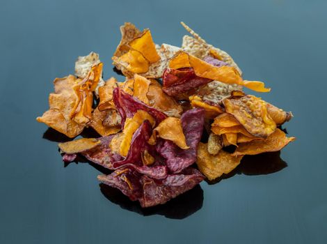 Mixed thai sweets made from sliced sweet potato coated with sugar (Potato chip) on blue table. Copy spce, Selective focus.