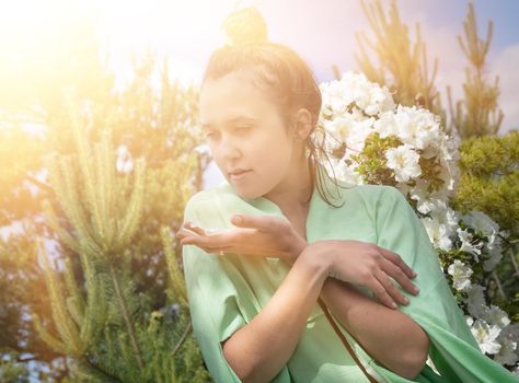 Japanese Garden. Young beautiful woman dressed in Japanese kimono in sun light
