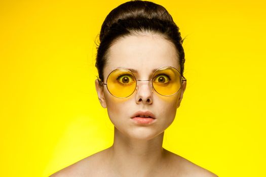 brunette with bare shoulders yellow glasses attractive look isolated background. High quality photo