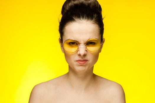 brunette paired keys fashionable yellow glasses close-up model. High quality photo
