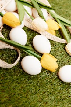 Easter eggs bouquet of tulips on the lawn holiday tradition. High quality photo