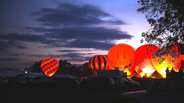 Hot Air Balloons in a Balloon Festival at Night Doing Night Glow Presentation