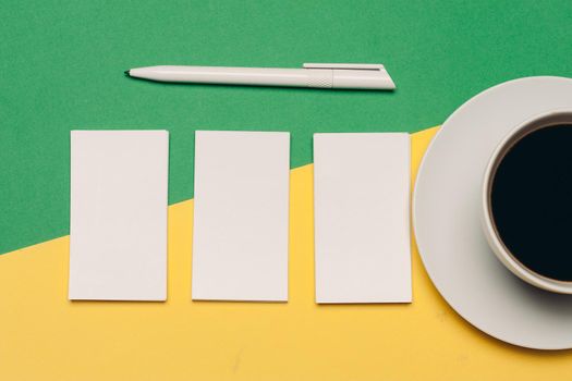 white business cards on bright background and ballpoint pen finance mockups. High quality photo