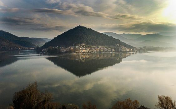 aerial photo of the lake and the village of piedilucwith a bit of fog