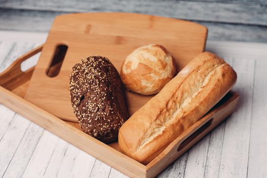 whole grain bread loaves homemade cakes cooking wood board close-up. High quality photo