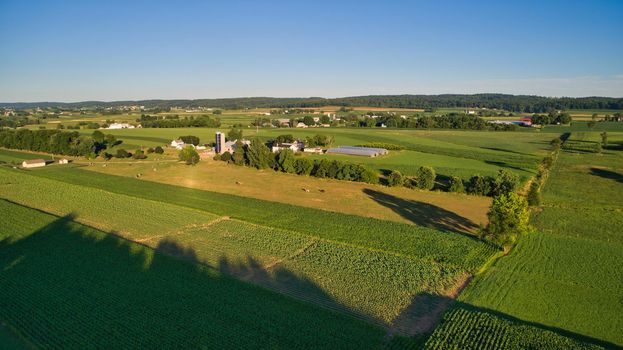An Aerial View on An Amish Farmlands with Crops and Cows on a Sunny Afternoon