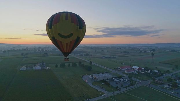 Hot Air Balloons Taking Off at Sunrise at a Hot Air Balloon Festival on a Misty Morning
