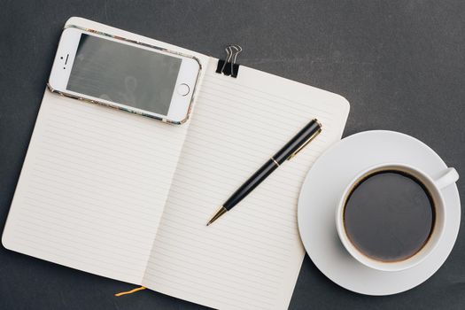 notebook on the table coffee cup pen office work business. High quality photo