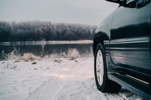 black car nature river winter trip travel landscape. High quality photo