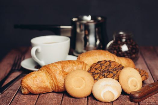 a cup of coffee cookies sweets wooden table snack. High quality photo