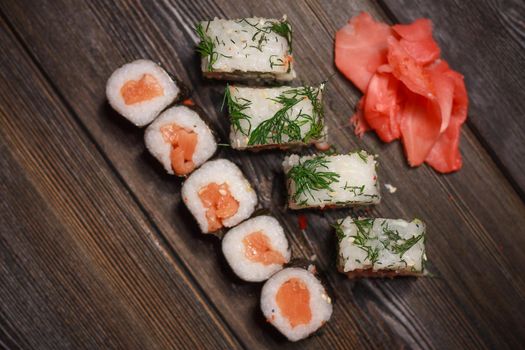 ginger seafood wooden table sushi and rolls delicacy. High quality photo