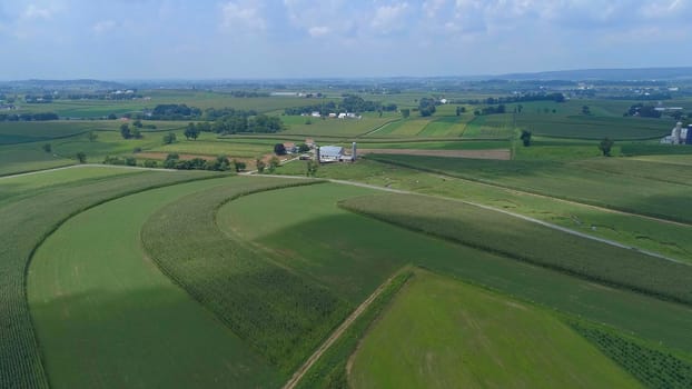 Aerial View of Green Farmlands With Different Crops Growing in the Fields on a Sunny Day