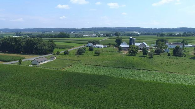 Aerial View of an Amish One Room School House in the Middle Of Amish Farmlands on a Sunny Day