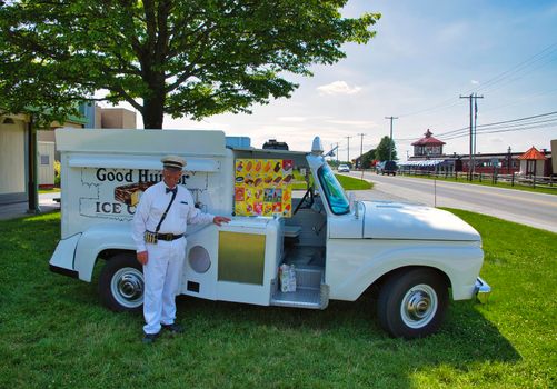 Strasburg, Pennsylvania, June 2018 - Old Restored Good Humor Ice Cream Truck and Owner Parked on Grass Selling Ice Cream
