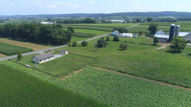 Aerial View of an Amish One Room School House in the Middle Of Amish Farmlands on a Sunny Day