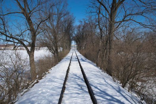 View of Rail Road Tracks Running Thru the Countryside Covered in Snow