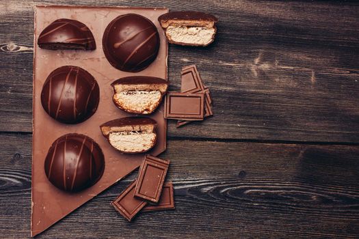 cake and chocolate bar on table wooden background texture delicacy. High quality photo