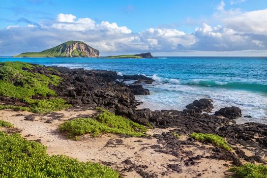 rocks close to Macapuu beach with Manana (also known Rabbit island) and Kaohikaipu islands in background, Oahu, Hawaii