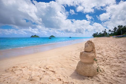 sandy woman on Lanikai Beach with Mokulua Islands in background, Kailua, O'ahu, Hawai'i