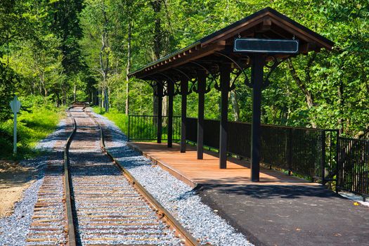 A Small Train Station Waiting for Passengers and a Train