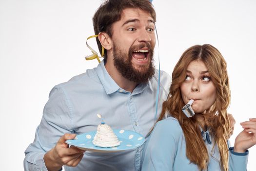 Joyful man and cheerful Woman holiday cake Birthday cap party corporate party young people. High quality photo