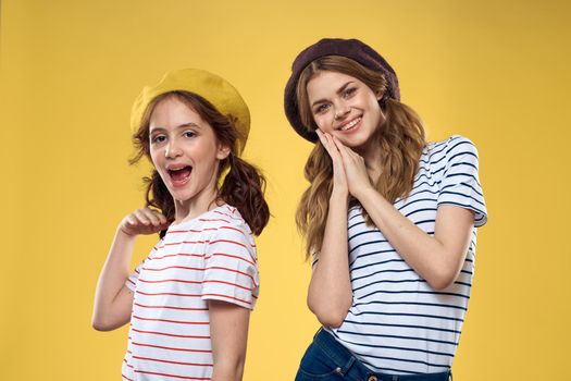Mom and daughter embrace joy fun childhood lifestyle yellow background. High quality photo
