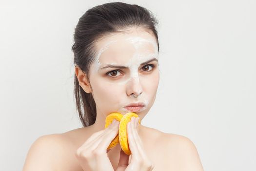 woman with sponges in hands cream mask on face cropped view. High quality photo