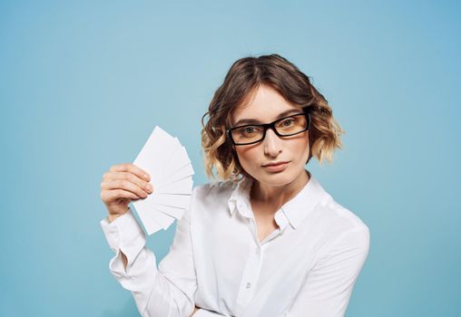 Business woman in shirt with a bundle of business cards in hand mockup. High quality photo