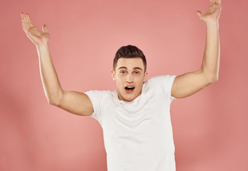 handsome man in white t-shirt lifestyle emotions pink background. High quality photo