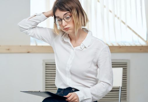 Business woman with a folder of documents in hands stress irritability emotions. High quality photo